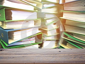 Wood table top over file stack at office background