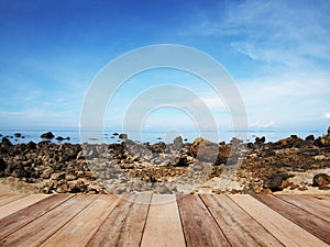 Wood table top over summer beach and blue sky