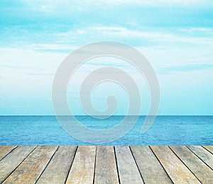 Wood table top over summer sea and blue sky with white clouds background