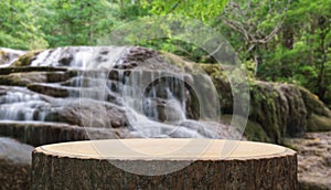 Wood table top podium floor in outdoor waterfall green tropical forest nature background.Natural water product present placement