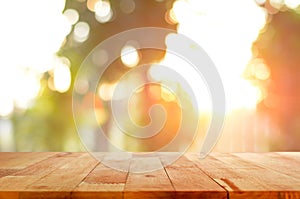 Wood table top on shiny sunlight bokeh background