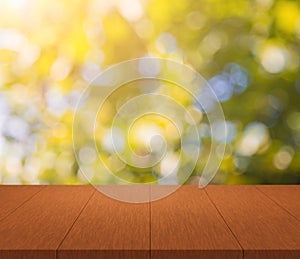 Wood table top on shiny sunlight bokeh background