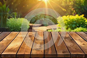 Wood table top on soft focus green garden with flower background. For montage product display.