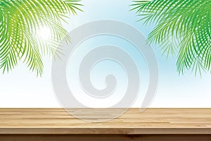 Wood table top on summer tropical sky background with green coconut leaves