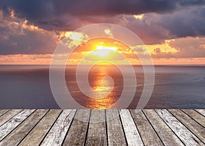 Wood table top on sunshine over sea in sunset