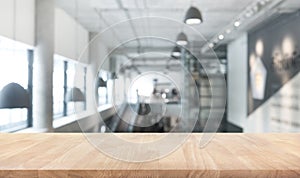 Wood table top texture on blur modern/contemporary building hall photo