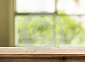 Wood table top on white abstract window glass background.