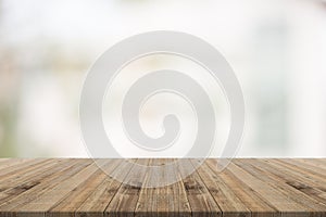 Wood table top on white blurred background from building