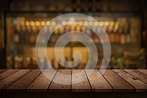 Wood table with a view of blurred beverages bar backdrop