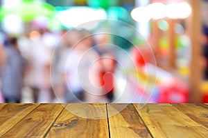 Wood tablr on shopping mall blur background with bokeh.