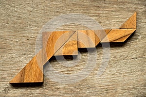 Wood tangram puzzle in gun shape background