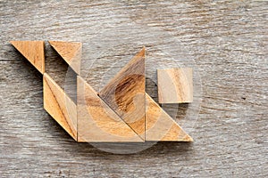 Wood tangram puzzle in human stumble and falling shape