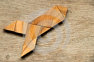Wood tangram puzzle in rocket shape background