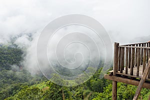 Wood terrace with view on mountain hills and mist