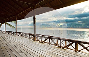 Wood terrace in wooden pavillion against peaceful of heaven sea photo