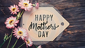 Wood texture background with happy Mothers Day tag, pink flowers