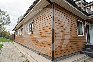 Wood texture composite cladding installation on house facade