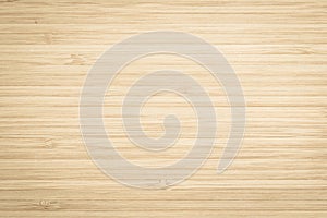 Wood texture old aged bamboo wooden kitchen cutting board grainy detail background in light gold brown beige color