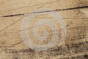 Wood texture. The surface of brown scratched wooden cutting board. Grunge textured wooden background.