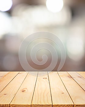 Wood texture table top counter bar with blur light abstract bokeh in cafe,restaurant background