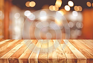 Wood texture table top counter bar with blur light gold bokeh in cafe,restaurant background