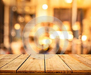 Wood texture table top counter bar with blur light gold bokeh in cafe,restaurant background