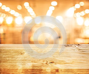 Wood texture table top counter bar with blur light gold bokeh in cafe,restaurant background