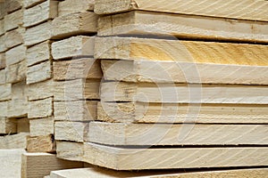 Wood, timber, construction material stacked in the warehouse