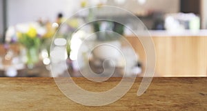 Wood top table Blur coffee shop or cafe restaurant with abstract bokeh light image background.