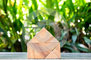 Wood toy as dream house concept with blurred green blackground