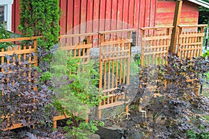 Wood Trellis Covering Red Barn Fencing