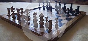 Wood turned chess board seen against the light