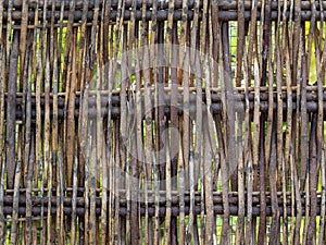 Wood twig wattle fence detail. Rustic background.