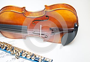 Wood violin body part with blue flute and score