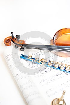 Wood violin detail with blue flute and score