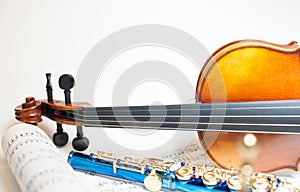 Wood violin detail with blue flute and score