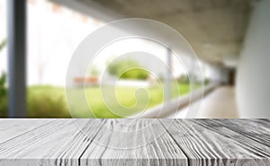 Wood white table top on blur building hall background form office building.For montage product display and design key visual