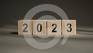 woodblocks cubes square with number 2023 on wood table. business goals next year. new year 2023 concept