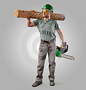 Woodcutter in helmet with chain saw and log photo
