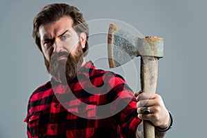 Woodcutter in a plaid shirt. Lumberjack brutal bearded man in red checkered shirt. concept of shaving. halloween. man