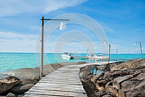 Wooded bridge in harbour against blue sky