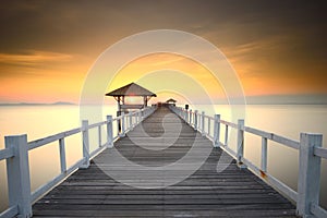 Wooded bridge in the port between sunrise.