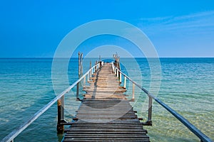 Wooded bridge into the sea