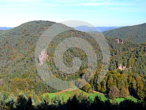 Wooded hilly landscape in autumn colors and sandstone cliffs