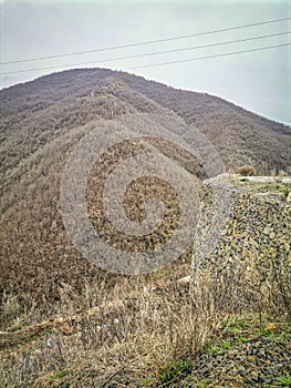 A wooded vally and road in the Highlands of near Kocani,