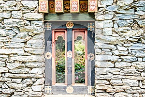 Wooded window and rock wall from bhutan