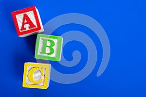 Wooden ABC blocks on blue background