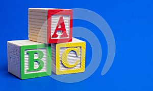 Wooden ABC blocks on blue background