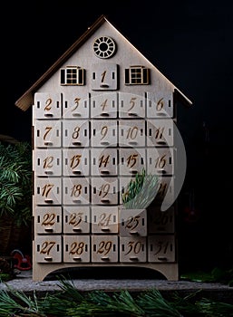 Wooden advent calendar for waiting new year or christmas. Box with cells from 1 to 25 and 31 for mini gifts. December