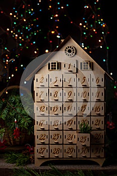 Wooden advent calendar for waiting new year or christmas. Box with cells from 1 to 25 and 31 for mini gifts. December atmosphere